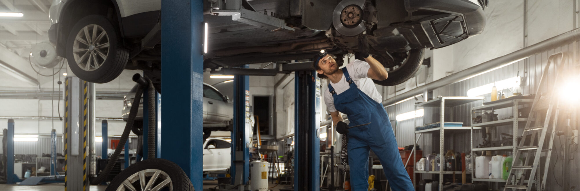 mechanic-working-car-suspension-repair-shop